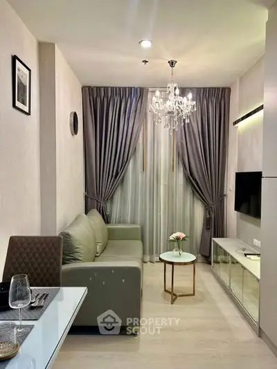 Elegant living room with modern decor, featuring a cozy sofa, chic chandelier, and stylish curtains.