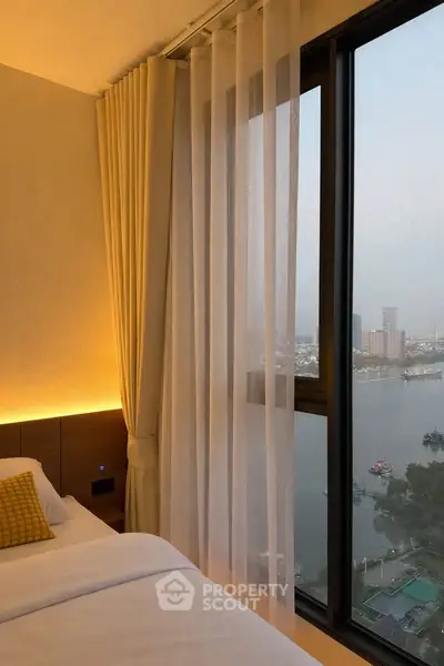 Luxurious bedroom with stunning river view and floor-to-ceiling windows