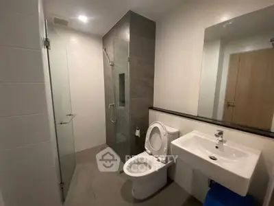 Modern bathroom with sleek fixtures and glass shower enclosure