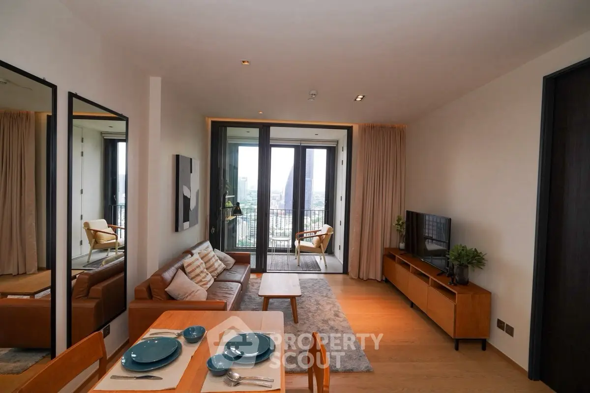 Modern living room with balcony view, stylish furniture, and elegant decor in a high-rise apartment.
