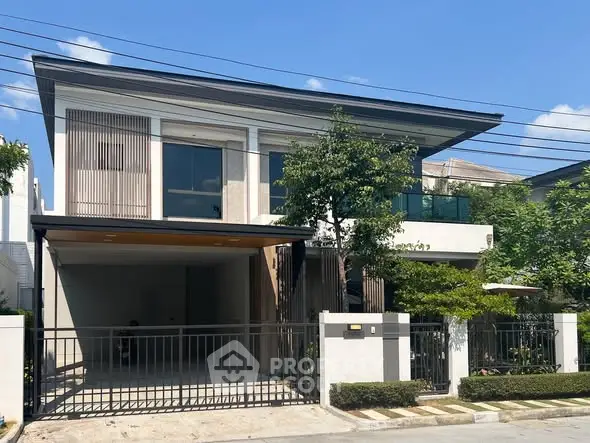Modern two-story house with sleek design and spacious driveway in a serene neighborhood.