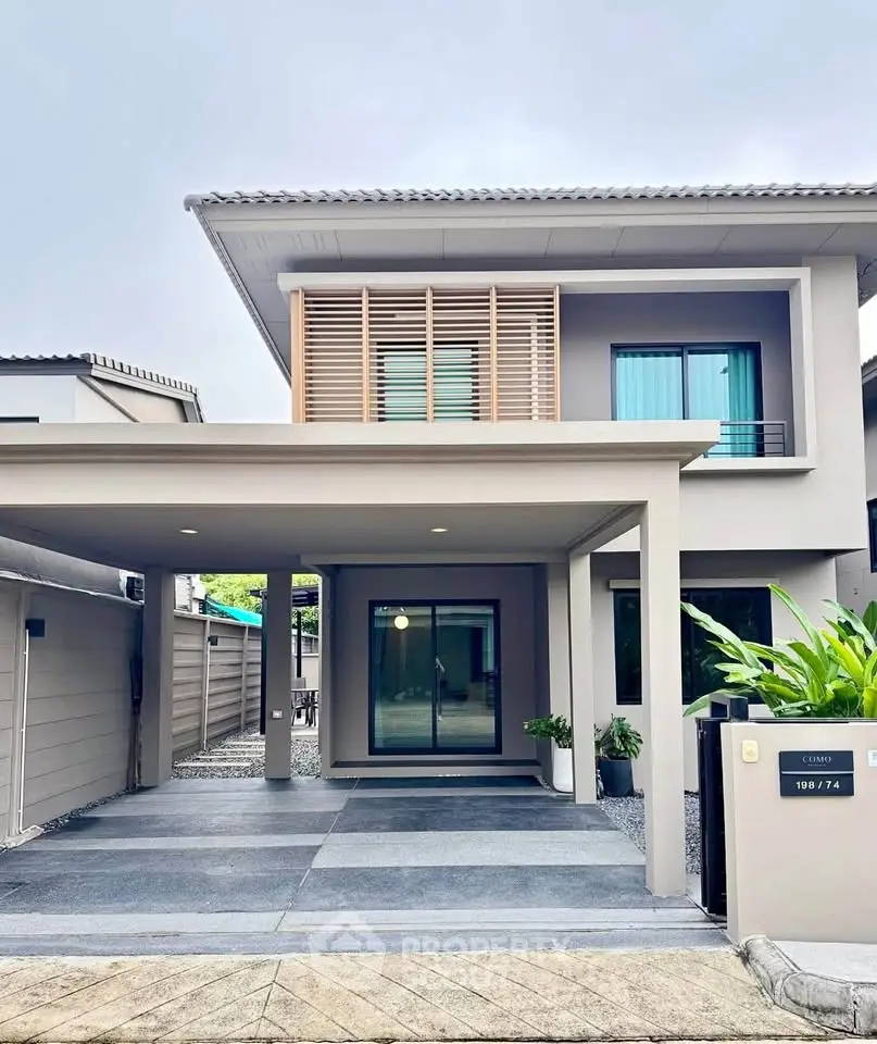 Modern two-story house with sleek design and spacious driveway in a serene neighborhood.