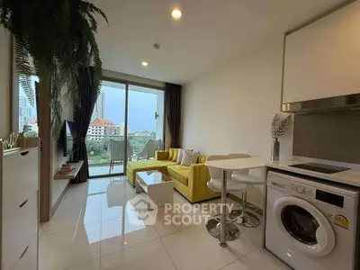 Modern living room with yellow sofa, washing machine, and city view balcony.