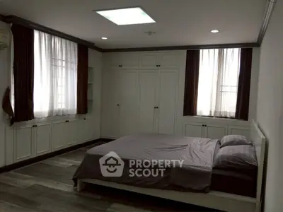 Spacious bedroom with elegant built-in wardrobes and cozy lighting.