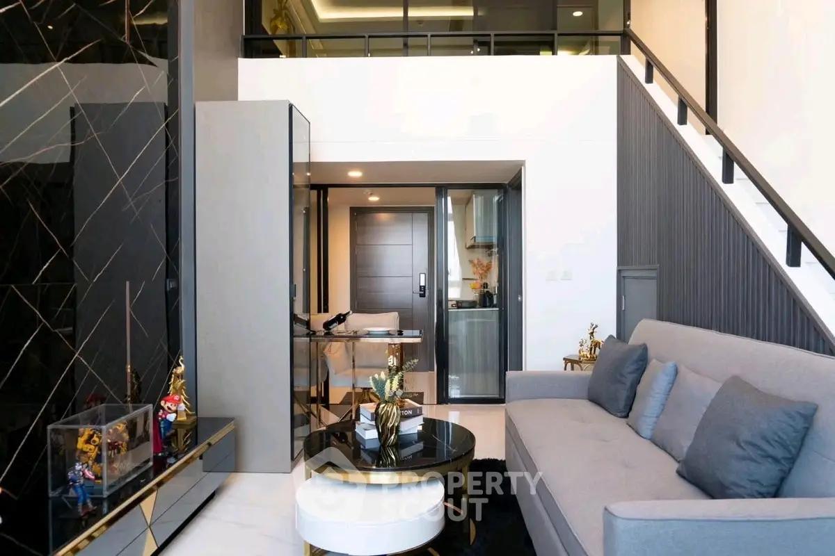 Modern duplex living room with stylish decor and elegant staircase