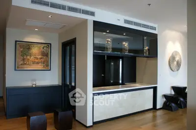 Modern living room with stylish decor and open layout, featuring elegant furniture and art pieces.
