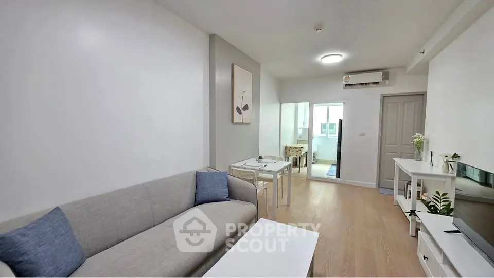 Modern living room with sleek furniture and open layout in a stylish apartment.