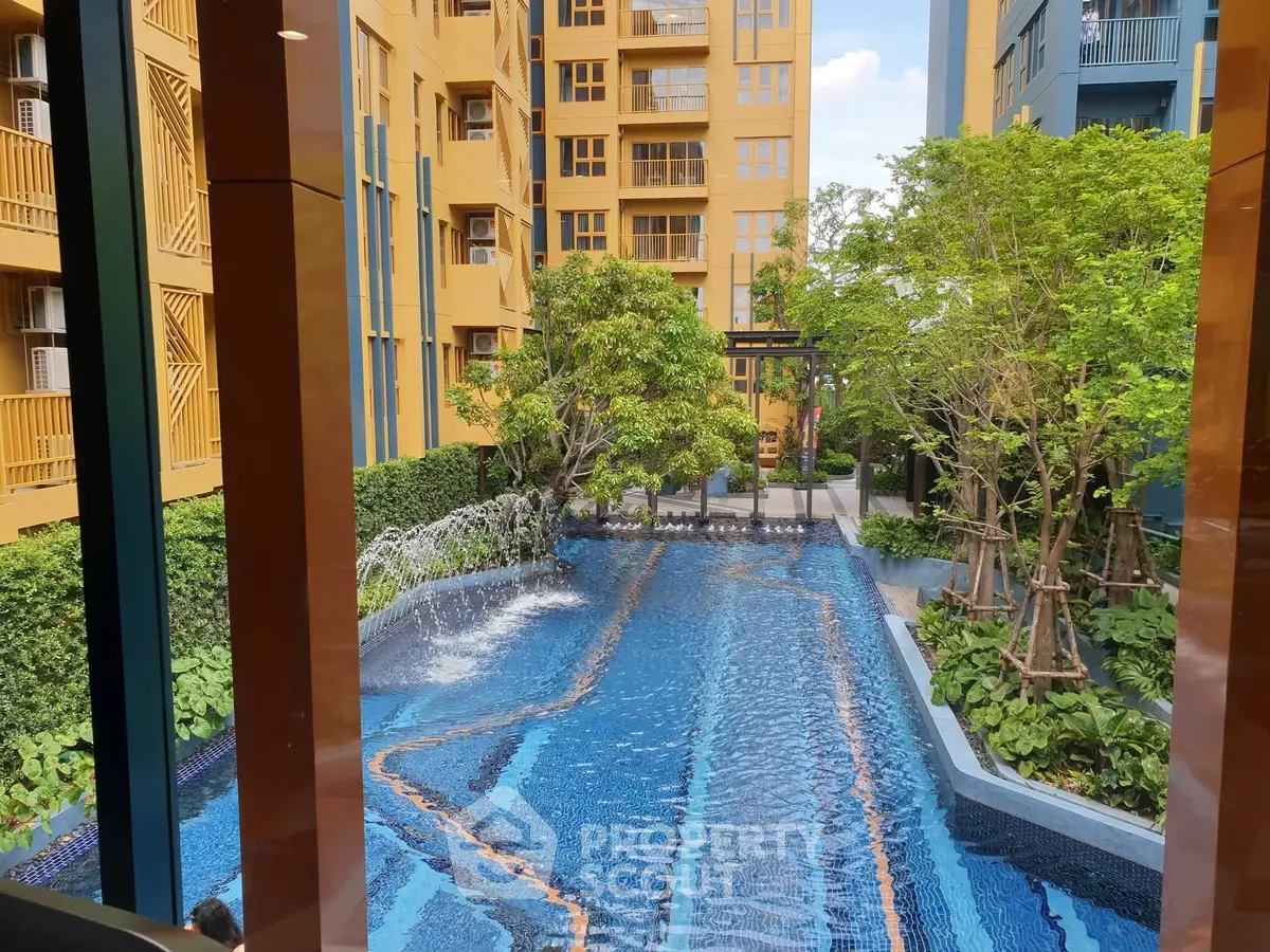 Luxurious apartment complex with stunning pool and lush greenery, perfect for relaxation and leisure.