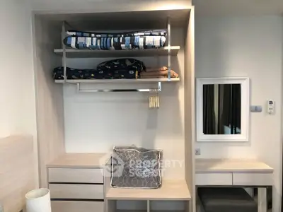 Modern bedroom with built-in storage and mirror, showcasing efficient space utilization.