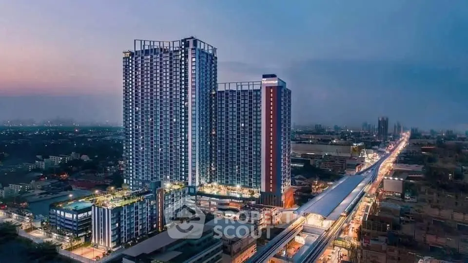 Stunning aerial view of modern high-rise residential buildings at dusk, showcasing urban living with cityscape backdrop.