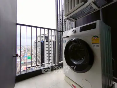 Modern high-rise balcony with city view and washing machine