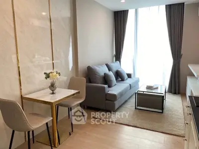 Modern living room with elegant decor and natural light in a stylish apartment.
