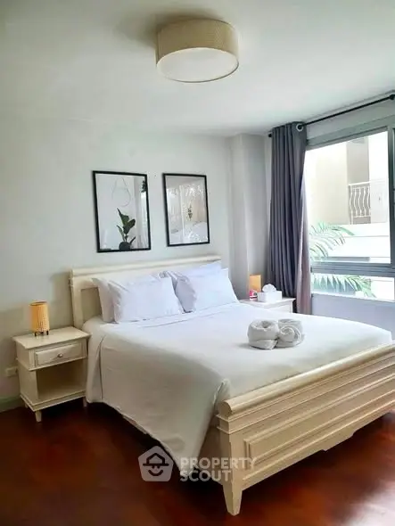Charming bedroom with elegant decor and natural light, perfect for relaxation and comfort.