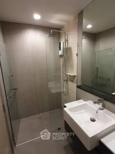 Modern bathroom with glass shower enclosure and sleek sink design