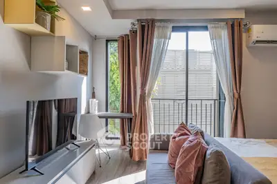 Modern living room with stylish decor and large window offering natural light