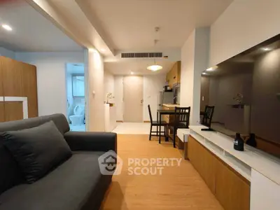 Modern living room with open kitchen layout and stylish decor