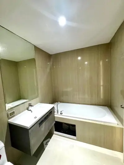 Modern bathroom with sleek design and built-in bathtub in luxury apartment.