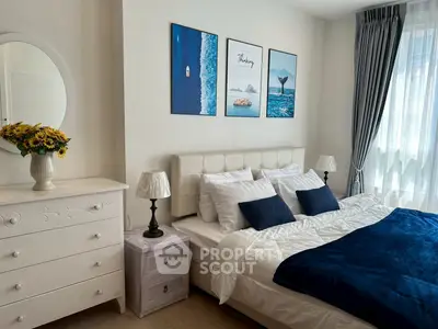 Charming bedroom with elegant decor and natural light, featuring cozy bedding and stylish artwork.