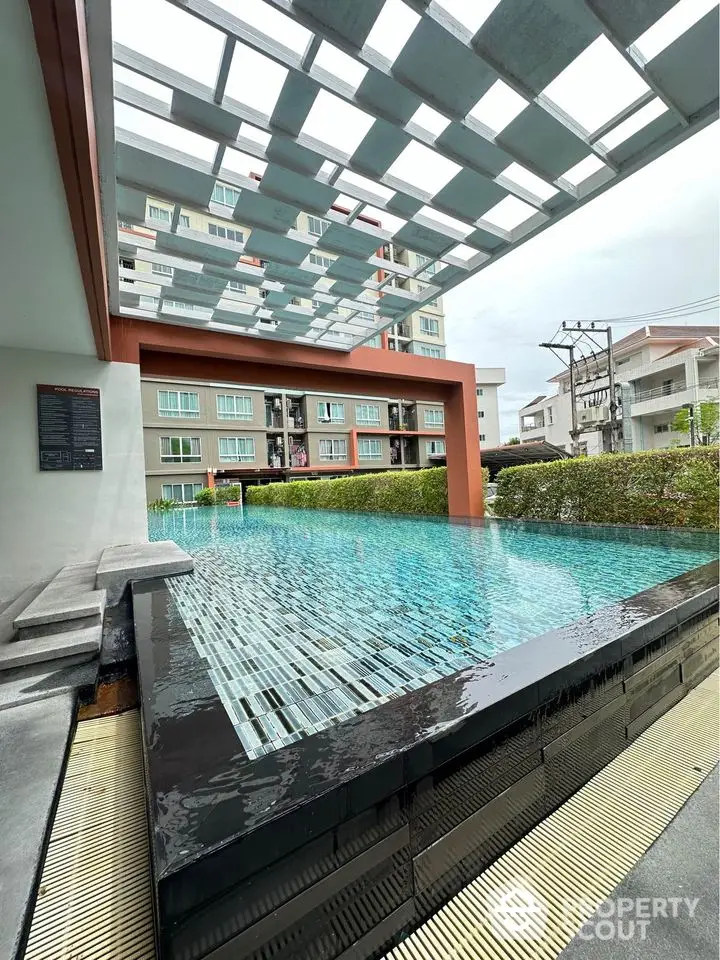 Stunning modern apartment complex with luxurious swimming pool and stylish architecture.