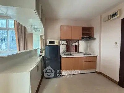 Modern kitchen with sleek cabinets and appliances in a high-rise apartment