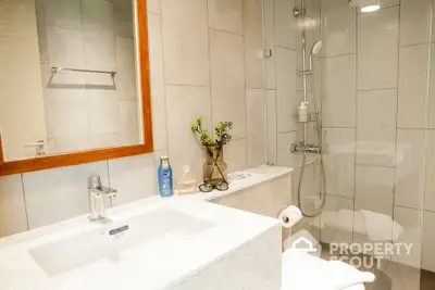 Modern bathroom with sleek fixtures and glass shower enclosure