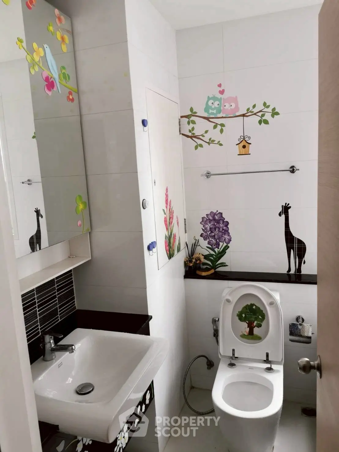 Charming bathroom with playful wall decals and modern fixtures