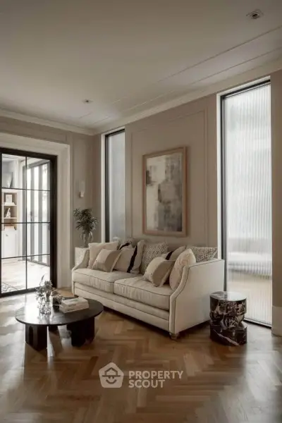 Elegant living room with stylish decor and natural light, featuring a cozy sofa and modern coffee table.