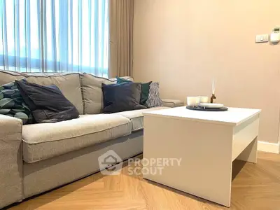 Cozy living room with modern sofa and stylish coffee table, perfect for relaxation.