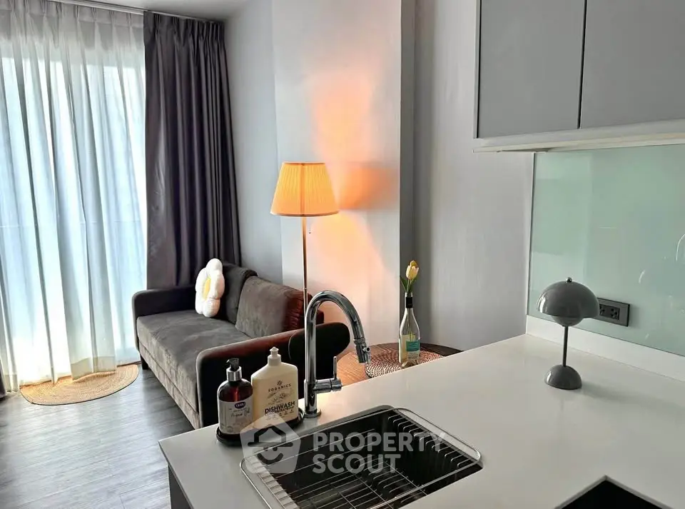 Modern apartment interior with cozy living room and stylish kitchen area, featuring sleek design and natural light.