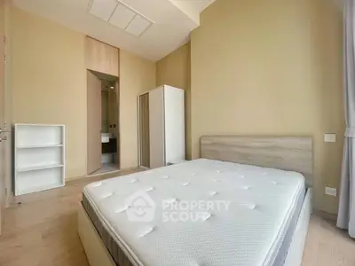 Spacious bedroom with modern design and ensuite bathroom in a stylish apartment.