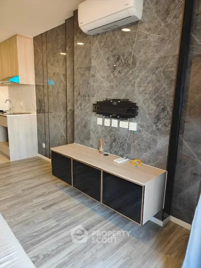 Modern living room with sleek marble wall and air conditioning unit