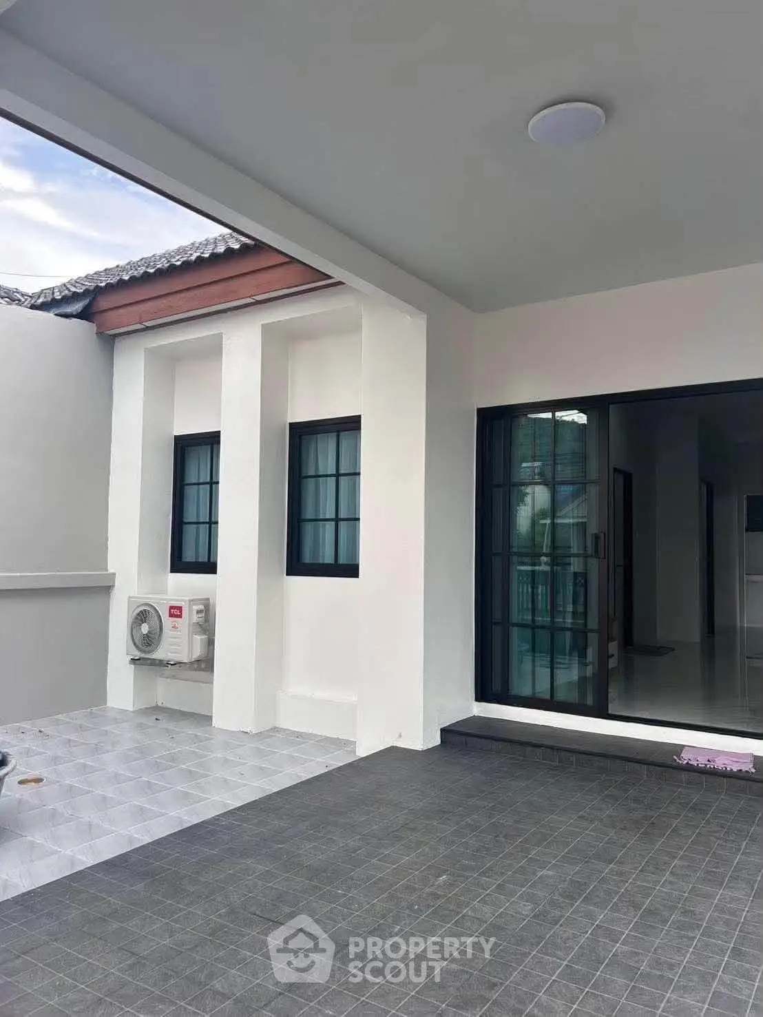 Modern home exterior with sleek design and spacious patio area.
