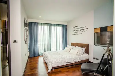 Modern bedroom with elegant decor and large windows for natural light