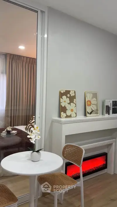 Charming living area with modern decor and cozy electric fireplace, perfect for relaxation and style.