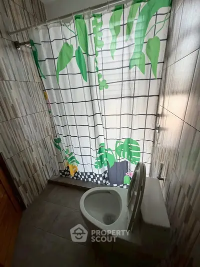 Cozy bathroom with modern tiled walls and vibrant shower curtain