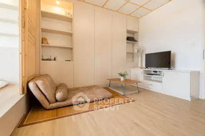 Modern minimalist living room with cozy seating and sleek storage solutions.