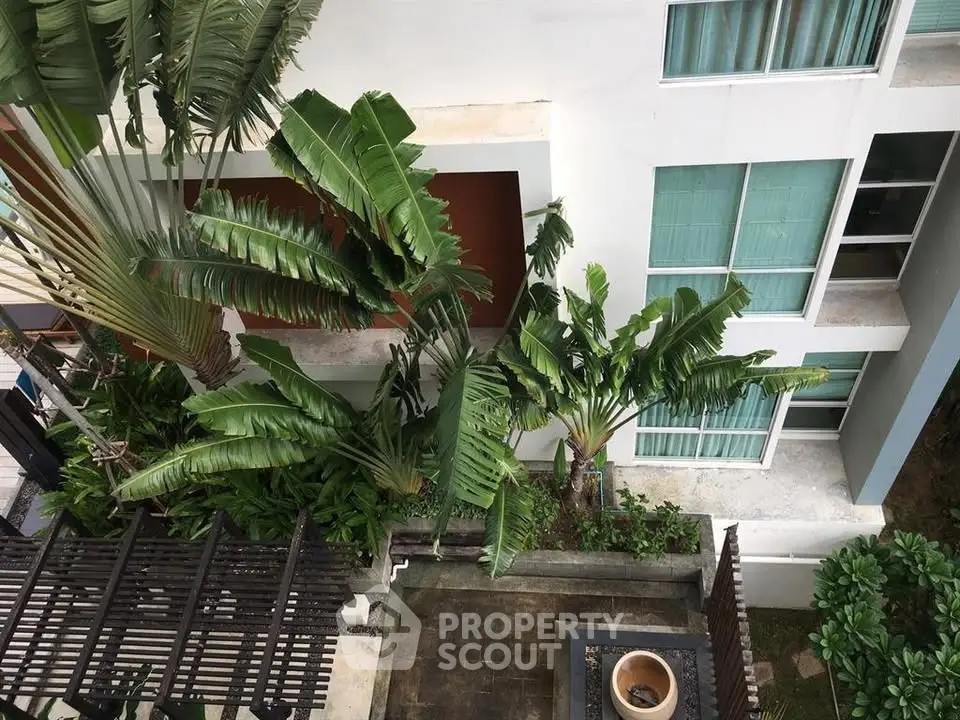 Modern apartment building with lush tropical garden view