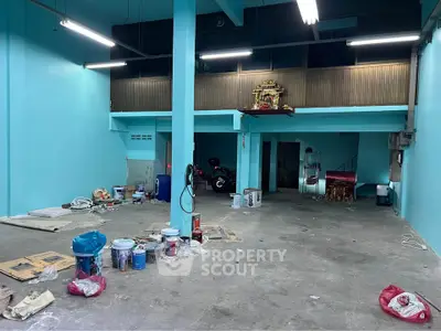 Spacious industrial-style interior with high ceilings and open layout, ideal for creative workspace or studio.