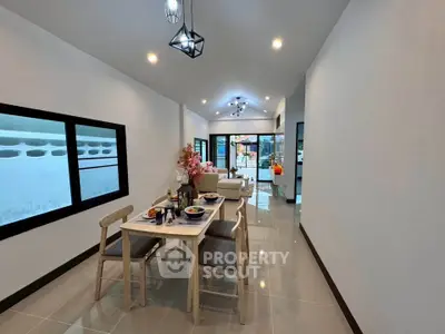 Modern open-plan living and dining area with elegant decor and ample natural light.