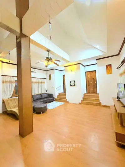 Spacious living room with wooden flooring and modern ceiling fan