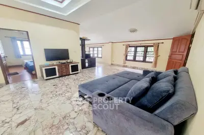 Spacious living room with marble flooring and modern furniture