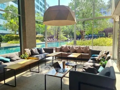 Luxurious poolside lounge with modern seating and lush garden views
