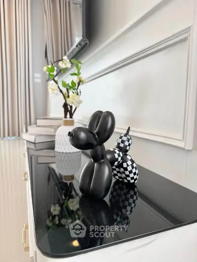 Stylish modern interior with decorative sculptures and elegant decor accents.