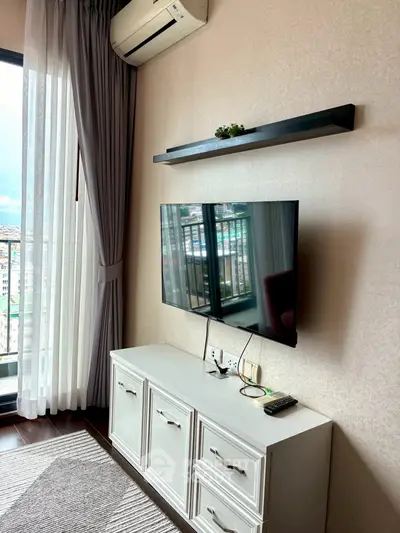 Modern living room with sleek TV setup and balcony view