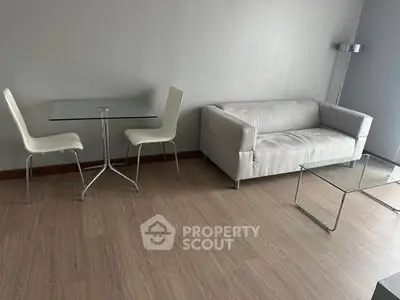 Modern minimalist living room with sleek furniture and wooden flooring