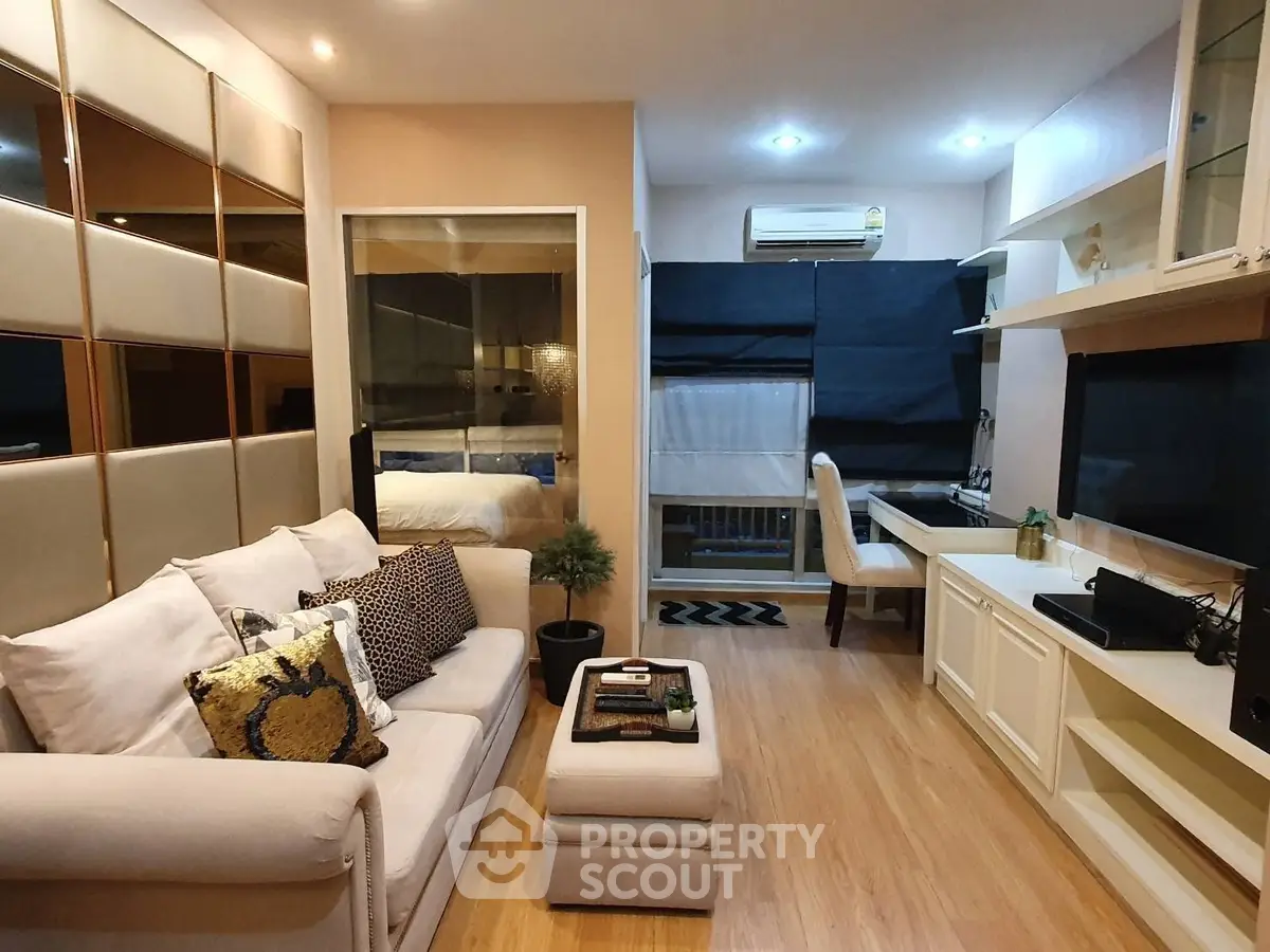 Modern living room with stylish decor and open layout, featuring cozy seating and sleek shelving.