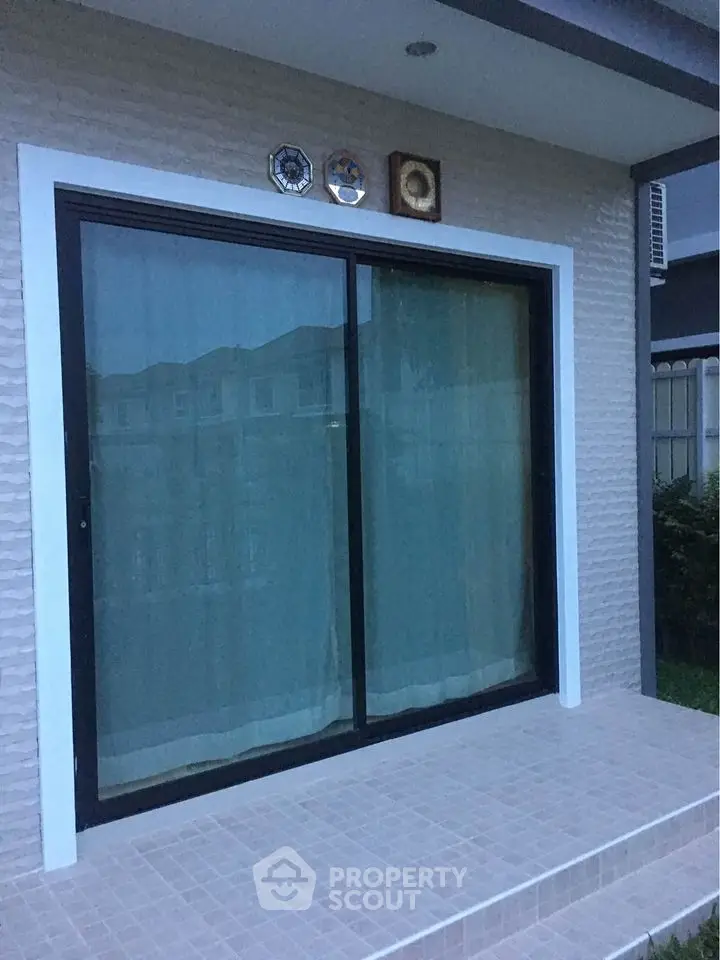 Modern patio with sliding glass doors and elegant tiled steps