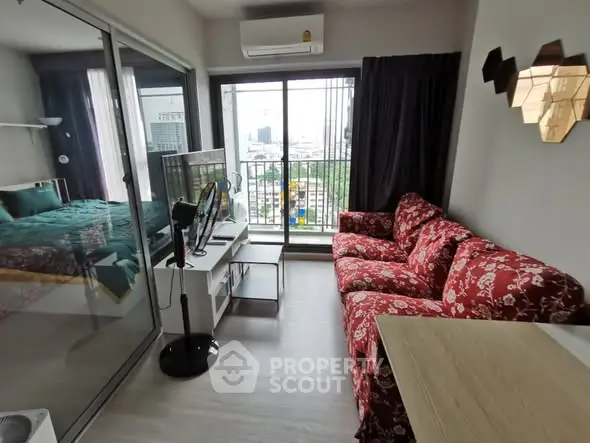 Modern living room with red floral sofa and city view balcony