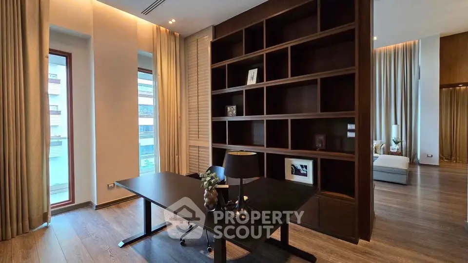 Luxurious study room with elegant wooden shelving and modern desk in upscale apartment.