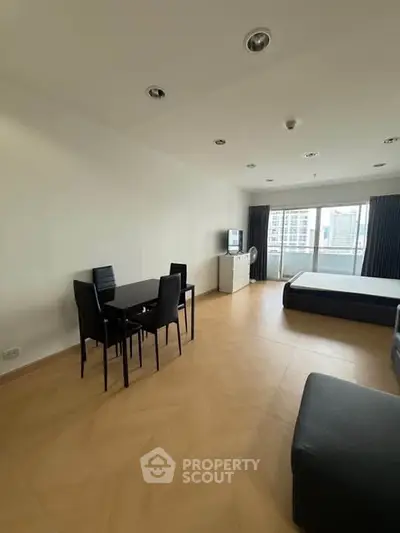 Spacious modern living room with dining area and city view, perfect for urban living.